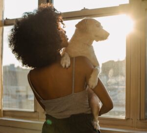 Photo by Samson Katt: https://www.pexels.com/photo/black-woman-holding-dog-near-window-5256719/